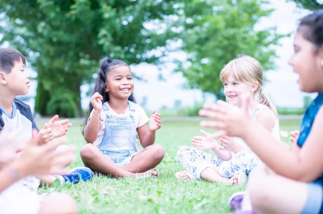 Children playing outdoors in the summertime, enjoying the sunshine and active play.